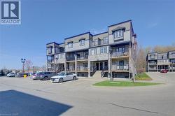 Multi-level building exterior featuring stone veneer and horizontal siding - 