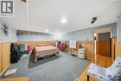 Spacious room featuring wood-finish paneling, textured wall covering, and recessed lighting - 116 Gainsborough Road, Hamilton, ON - Indoor
