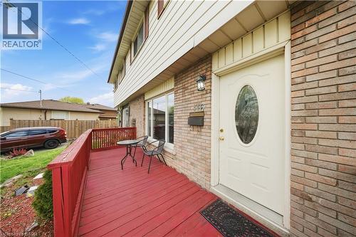 Brick and siding exterior featuring a red-painted wood deck - 116 Gainsborough Road, Hamilton, ON - Outdoor With Exterior