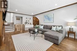 Living area featuring wood-finish flooring and a white shiplap ceiling - 