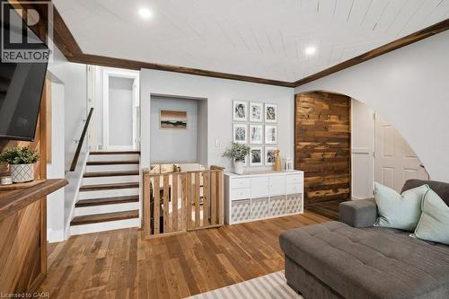 Living area featuring wood-finish flooring, a white shiplap ceiling with recessed lighting, and dark wood beams - 522 Glendene Crescent, Waterloo, ON - Indoor Photo Showing Other Room