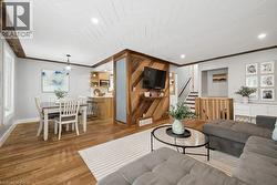 Open-concept living space with wood-finish flooring - 