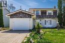 Two-story residence featuring a shingle and siding exterior, a front-facing garage with a paver driveway, and a partially landscaped front yard - 277 Blackacres Boulevard, London, ON  - Outdoor 