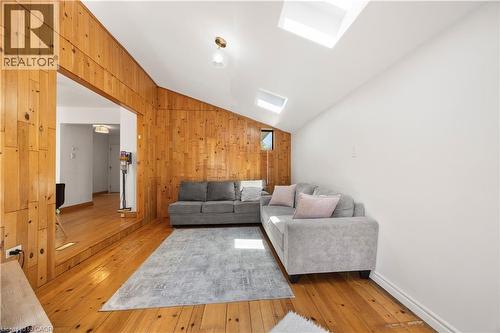Living area featuring wood-finish flooring and a wood-paneled accent wall - 277 Blackacres Boulevard, London, ON - Indoor