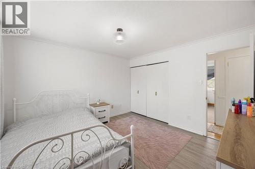 Bedroom featuring light wood-finish flooring, white walls, and a ceiling-mounted light fixture - 277 Blackacres Boulevard, London, ON - Indoor Photo Showing Bedroom