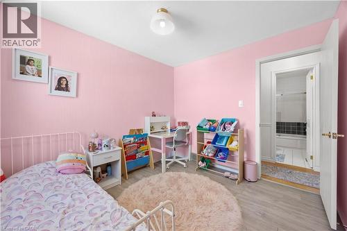 Bedroom featuring light pink walls and wood-finish flooring - 277 Blackacres Boulevard, London, ON - Indoor Photo Showing Bedroom