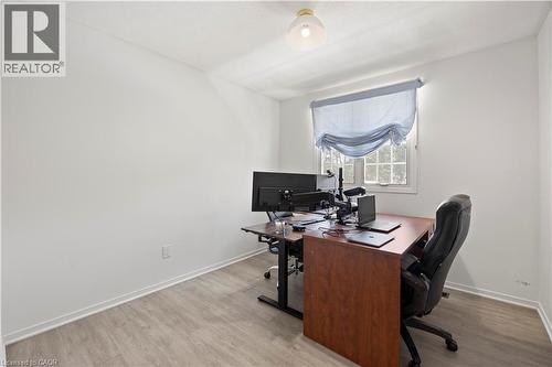 Room featuring light wood-finish flooring, white walls, and a single pane window with a light blue Roman shade - 277 Blackacres Boulevard, London, ON - Indoor Photo Showing Office