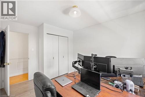 Neutral wall finishes, a brass-tone flush mount light fixture, and a built-in closet with white bifold doors - 277 Blackacres Boulevard, London, ON - Indoor Photo Showing Other Room