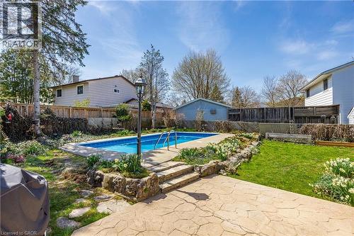 Backyard featuring an in-ground swimming pool with concrete surround and metal handrails - 277 Blackacres Boulevard, London, ON - Outdoor With In Ground Pool With Backyard