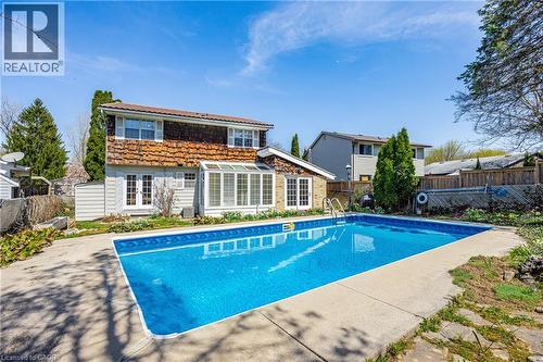 Rear exterior featuring a rectangular in-ground pool with concrete surround - 277 Blackacres Boulevard, London, ON - Outdoor With In Ground Pool With Backyard
