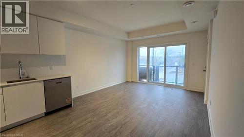 Open-concept living area featuring wood-finish flooring, white walls, and recessed lighting - 16 Melbourne Avenue Unit# 210B, St. Catharines, ON - Indoor