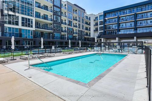 431 - 16 Concord Place, Grimsby, ON - Outdoor With In Ground Pool With Facade