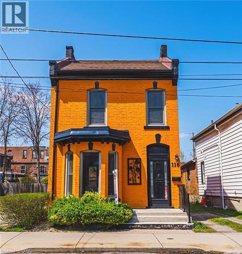 Vibrant orange brick facade with black trim detailing - 116 Catharine Street S, Hamilton, ON - Outdoor
