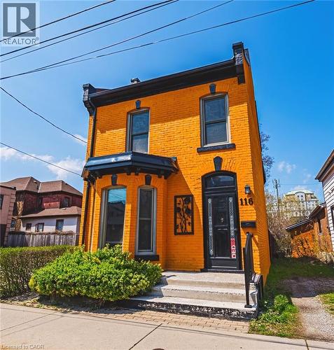 Vibrant yellow brick facade with contrasting black trim - 116 Catharine Street S, Hamilton, ON - Outdoor