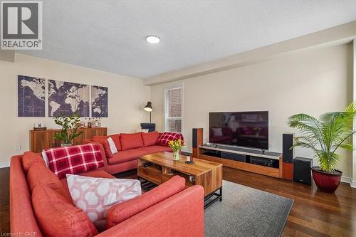 Living area featuring wood-finish flooring, a large window with natural light, and recessed ceiling lighting - 4679 Webb Street, Burlington, ON - Indoor Photo Showing Living Room