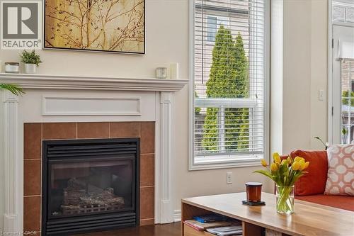 Fireplace featuring a white mantel, tile surround, and a gas insert - 4679 Webb Street, Burlington, ON - Indoor Photo Showing Living Room With Fireplace