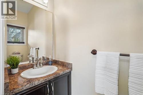 Bathroom vanity featuring a polished chrome faucet, an oval sink, and a multi-toned countertop - 4679 Webb Street, Burlington, ON - Indoor Photo Showing Bathroom