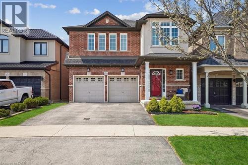 Two-story brick and stucco exterior with an attached two-car garage - 4679 Webb Street, Burlington, ON - Outdoor With Facade