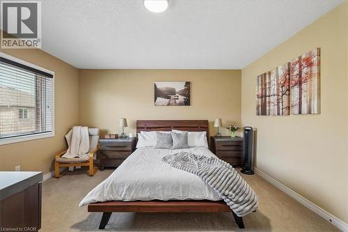 Spacious bedroom featuring neutral wall tones, carpeted flooring, and a large window with blinds - 4679 Webb Street, Burlington, ON - Indoor Photo Showing Bedroom