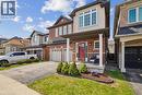 Brick and stucco exterior with a covered front porch and a distinctive red entry door - 4679 Webb Street, Burlington, ON  - Outdoor With Facade 