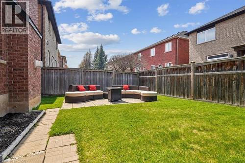 Private backyard featuring a paver patio and expansive green lawn - 4679 Webb Street, Burlington, ON - Outdoor