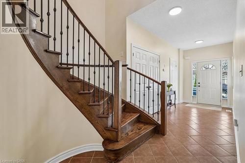 Foyer featuring a curved staircase with wood treads and wrought iron balusters - 4679 Webb Street, Burlington, ON - Indoor Photo Showing Other Room