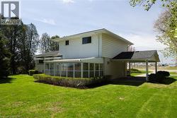 Exterior with white siding and a covered carport - 