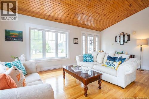 Knotty-pine vaulted ceiling over livingroom and kitchen - 8 Dane Row, Willow Grove, NB - Indoor Photo Showing Living Room