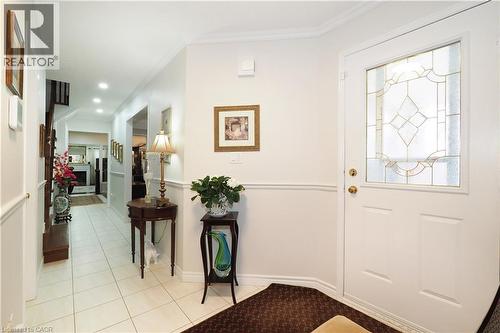 Foyer entrance featuring light tile patterned flooring and ornamental molding - 89 Lynnhaven Court, Kitchener, ON - Indoor Photo Showing Other Room