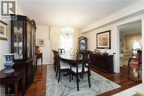Dining area with ornamental molding, suspended lighting, and dark wood-type flooring - 89 Lynnhaven Court, Kitchener, ON - Indoor Photo Showing Dining Room
