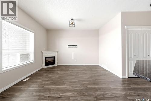 401 3826 Dewdney Avenue E, Regina, SK - Indoor Photo Showing Other Room With Fireplace