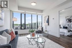 Light-filled living area featuring floor-to-ceiling windows, - 