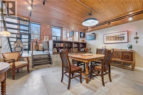 Dining space featuring wood ceiling, track lighting, and concrete flooring - 85 Spruce Street Unit# 106, Cambridge, ON - Indoor Photo Showing Dining Room