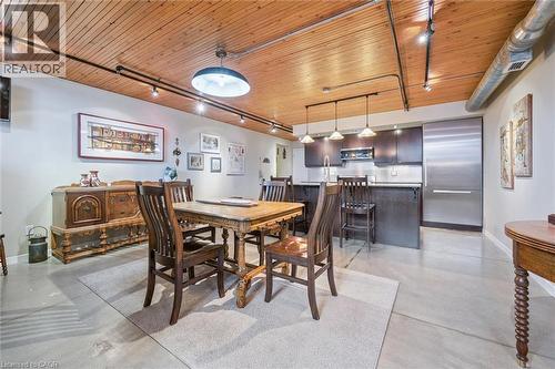 Dining area with rail lighting, concrete floors, and wooden ceiling - 85 Spruce Street Unit# 106, Cambridge, ON - Indoor Photo Showing Dining Room