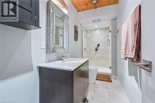 Bathroom featuring a stall shower, vanity, light tile patterned flooring, and wood ceiling - 85 Spruce Street Unit# 106, Cambridge, ON - Indoor Photo Showing Bathroom