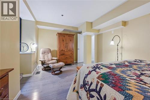Bedroom with dark wood finished floors and baseboards - 85 Spruce Street Unit# 106, Cambridge, ON - Indoor Photo Showing Bedroom