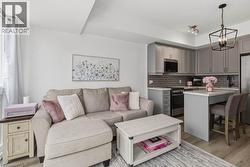Open-concept living area featuring wood-finish flooring - 