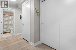 Hall with baseboards and light wood-style flooring - 