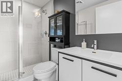 Bathroom featuring a stall shower and vanity - 