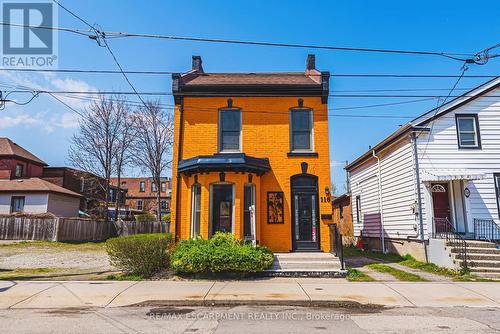 Vibrant orange brick facade w/black trim detailing - 116 Catharine Street S, Hamilton, ON 