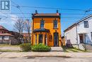 Vibrant orange brick facade w/black trim detailing - 116 Catharine Street S, Hamilton, ON 