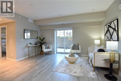 Open-concept living area featuring light wood-finish flooring, recessed lighting, and neutral wall tones - 16 Markle Crescent Unit# 111, Ancaster, ON - Indoor Photo Showing Living Room