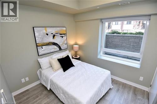 Room featuring wood-finish flooring, a contemporary window, recessed lighting, and light-toned walls - 16 Markle Crescent Unit# 111, Ancaster, ON - Indoor Photo Showing Bedroom