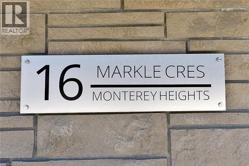 Modern address plaque featuring a brushed metal finish and black lettering, mounted on a stacked stone facade - 16 Markle Crescent Unit# 111, Ancaster, ON - 