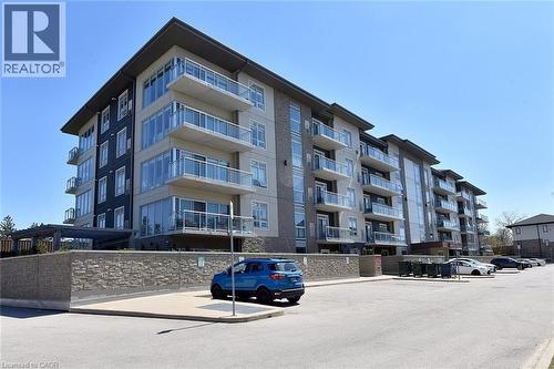 Modern multi-story building featuring expansive glass balconies - 16 Markle Crescent Unit# 111, Ancaster, ON - Outdoor With Facade
