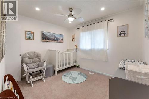 Carpeted bedroom with ceiling fan, a crib, and recessed lighting - 32 Donly Drive N, Simcoe, ON - Indoor Photo Showing Bedroom