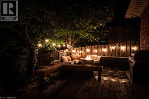 Deck at night featuring grilling area and an outdoor living space with a fire pit - 32 Donly Drive N, Simcoe, ON - 