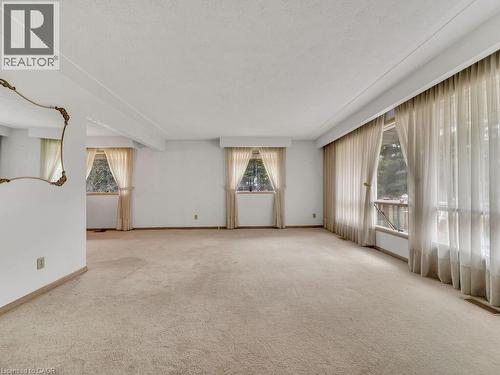 Expansive interior space featuring light-toned carpeting and white walls - 1416 Highway 6, Hamilton, ON - Indoor Photo Showing Other Room