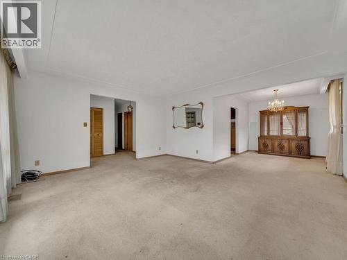 Expansive living area with neutral carpeting and white walls - 1416 Highway 6, Hamilton, ON - Indoor