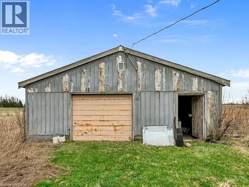 Utility building featuring a single garage door and an additional entry point - 1416 Highway 6, Hamilton, ON - Outdoor With Exterior